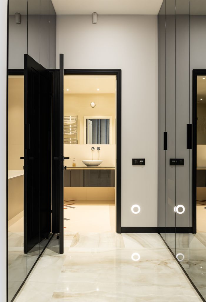 services-03 Interior of modern house with big glass cabinets near door to bathroom with sink on counter